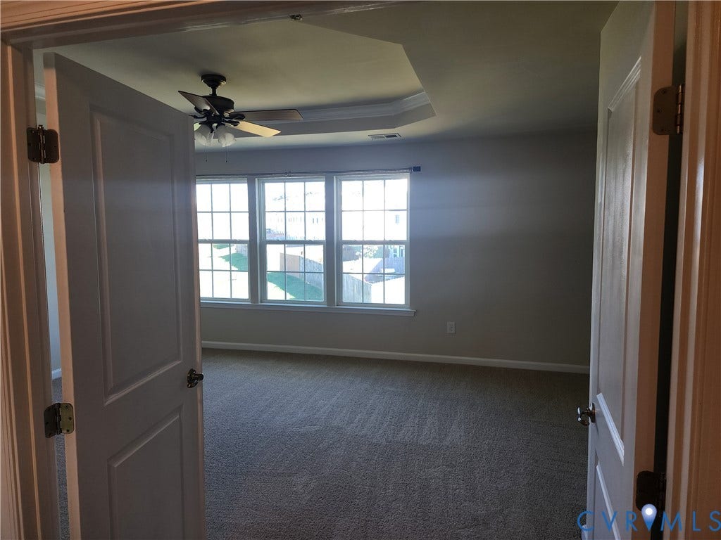 9031 Annex Lane, Mechanicsville, VA 23116 Double-door entry featuring neutral wall-to-wall carpeting, tray ceiling, integrated ceiling fan with light kit, and a triple-pane grid window configuration