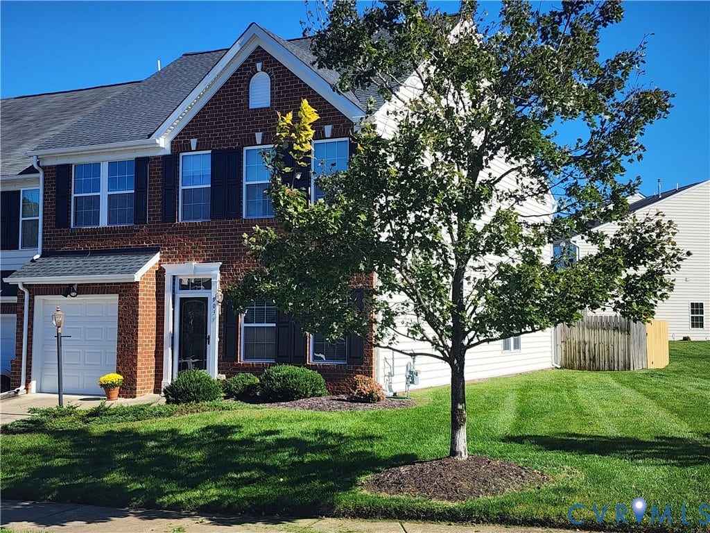 9031 Annex Lane, Mechanicsville, VA 23116 Two-story brick and siding exterior featuring dark shutters, a gabled roofline, an attached one-car garage, and a manicured lawn