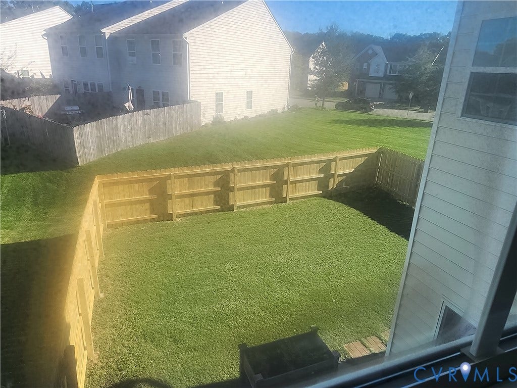 9031 Annex Lane, Mechanicsville, VA 23116 Rear yard featuring a grass lawn, wood-post fencing, and exterior siding