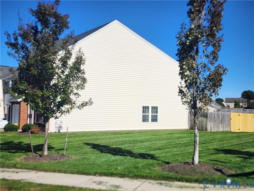 9031 Annex Lane, Mechanicsville, VA 23116 Light-toned siding exterior with double-pane windows, mature trees, and a grass lawn