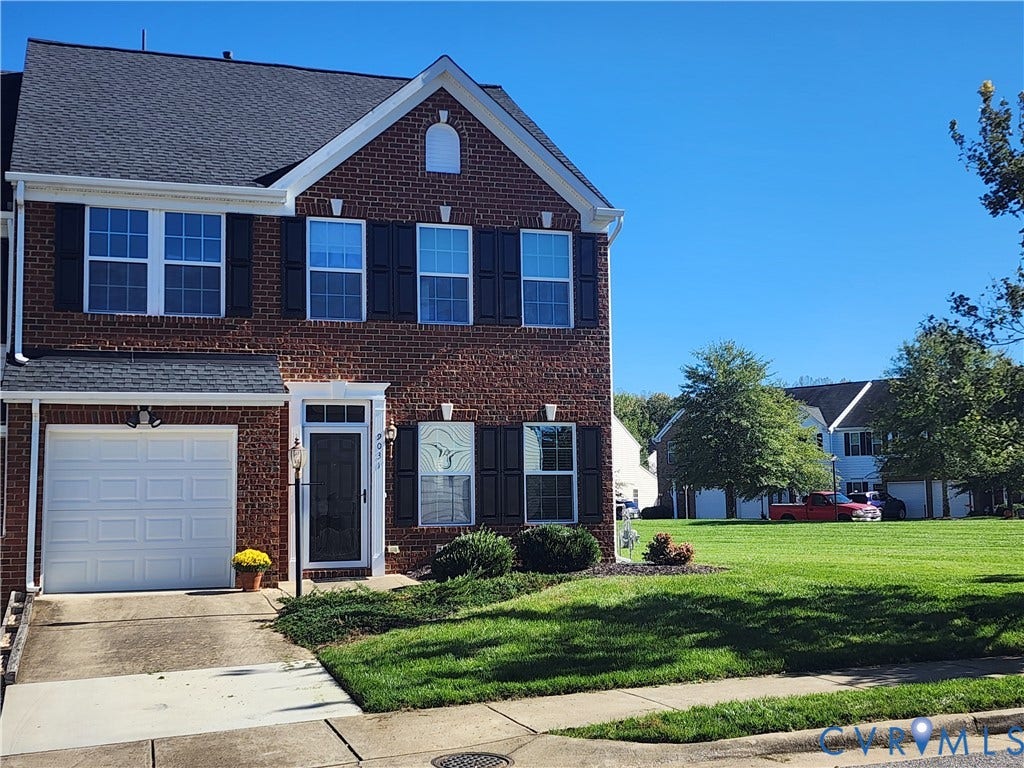 9031 Annex Lane, Mechanicsville, VA 23116 Two-story brick exterior featuring a shingled roof, black louvered shutters, an integrated single-car garage, and a concrete driveway