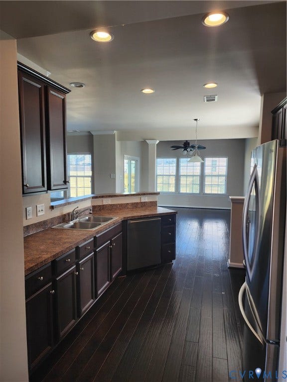 9031 Annex Lane, Mechanicsville, VA 23116 Kitchen featuring dark wood-finish cabinetry, stainless steel appliances, dual-basin sink, and recessed lighting, with wood-finish flooring extending throughout the area