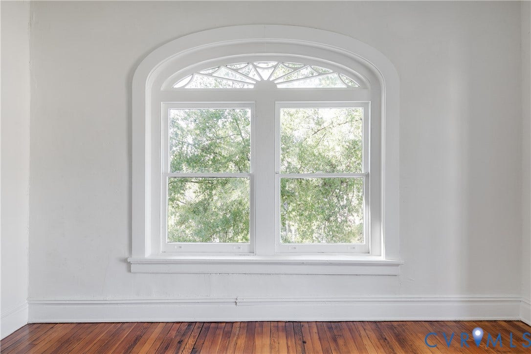 2005 Barton Avenue, Barton Heights, Richmond, VA 23222 Arched window featuring a segmented fanlight, double-hung sash, and detailed trim, set against neutral wall finishes and wood-finish flooring
