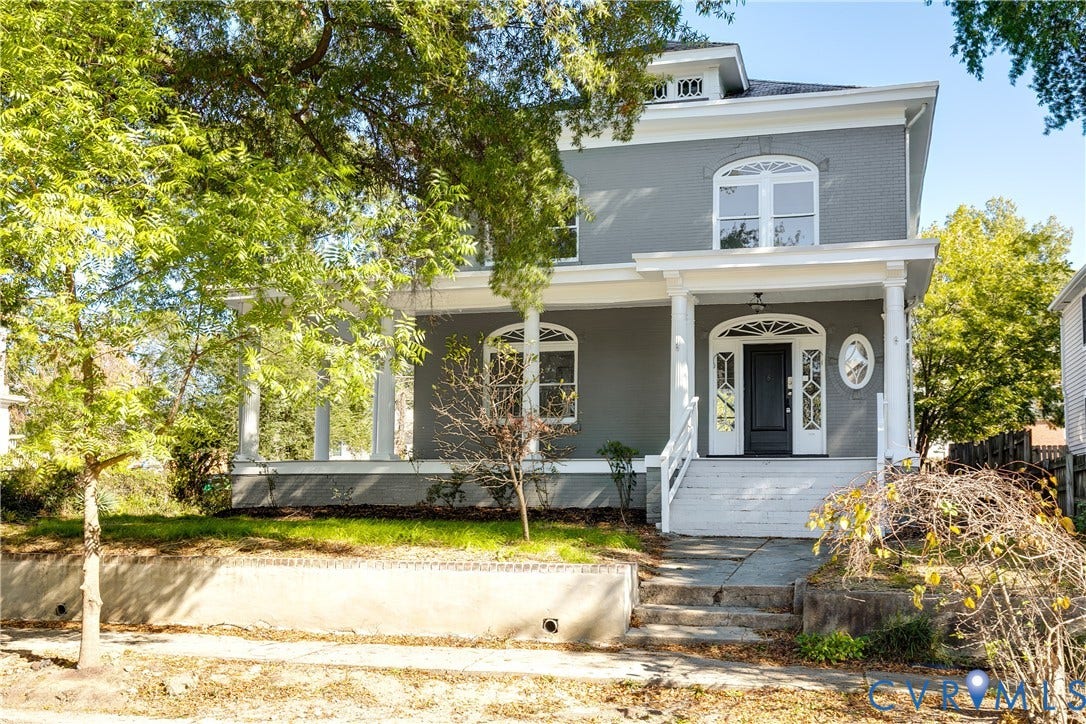 2005 Barton Avenue, Barton Heights, Richmond, VA 23222 Two-story exterior featuring painted masonry siding, a wrap-around porch with classical columns, arched window detailing, and a front entrance with an arched transom and sidelights