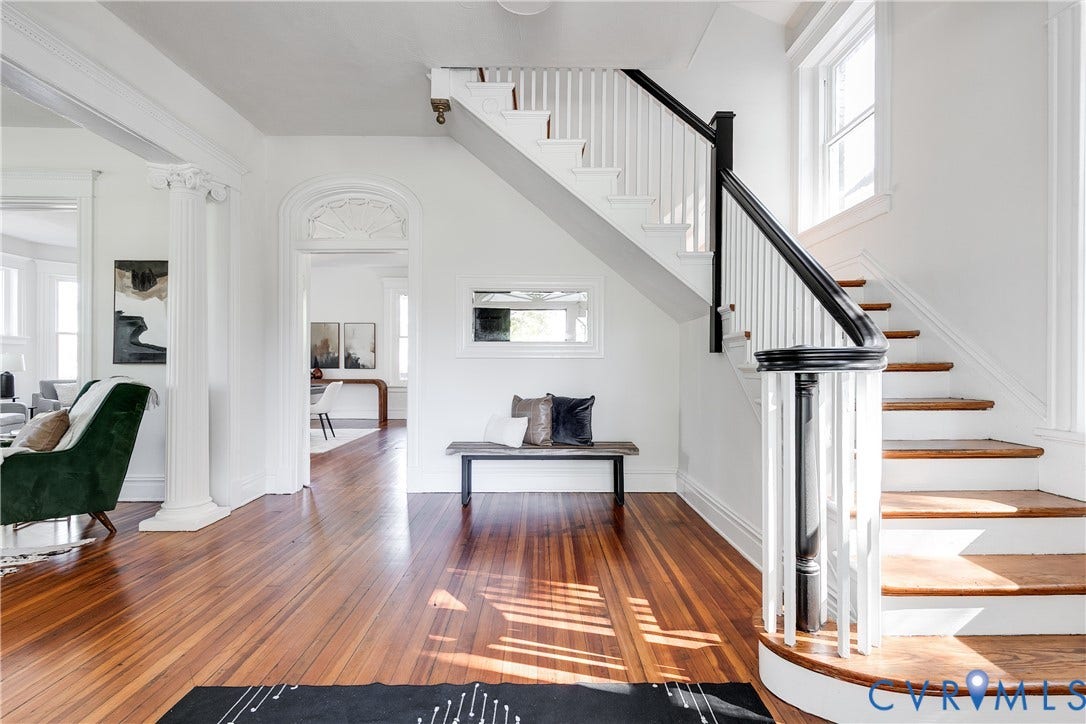 2005 Barton Avenue, Barton Heights, Richmond, VA 23222 Foyer featuring wood-finish flooring, a classic staircase with a decorative banister, structural columns, and arched doorway detailing