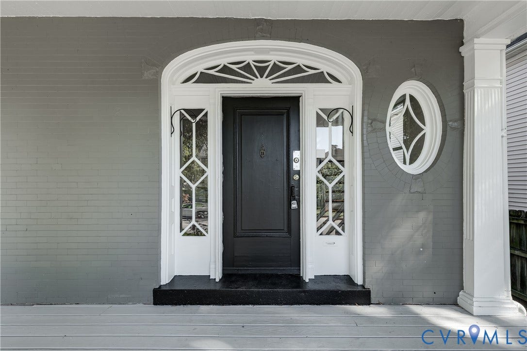 2005 Barton Avenue, Barton Heights, Richmond, VA 23222 Painted brick exterior featuring a front entrance with a sunburst transom window, decorative sidelights, an oval accent window, and a fluted porch column