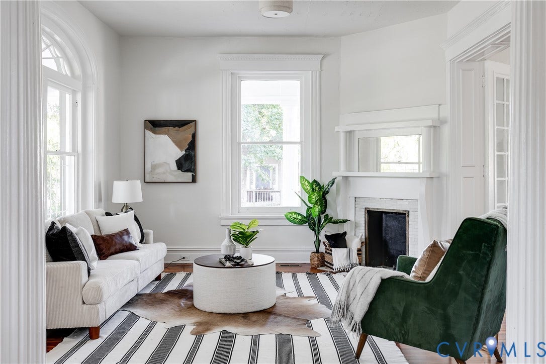 2005 Barton Avenue, Barton Heights, Richmond, VA 23222 Architectural detailing featuring arched window trim, wood-finish flooring, a fireplace with a decorative mantel, and fluted column casing