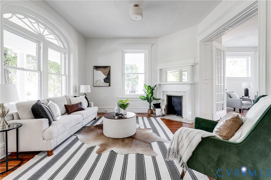 2005 Barton Avenue, Barton Heights, Richmond, VA 23222 Living area featuring wood-finish flooring, a fireplace with an ornate mantel and mirror, large arched windows with transoms, and French doors