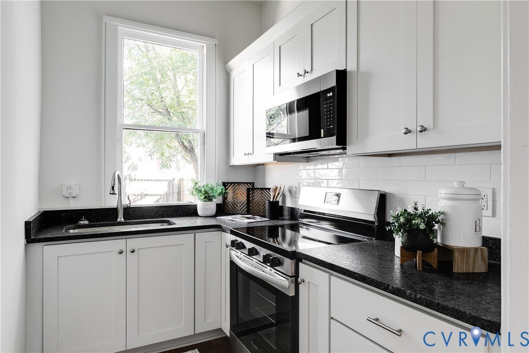 2005 Barton Avenue, Barton Heights, Richmond, VA 23222 White shaker-style cabinetry, dark stone countertops, stainless steel appliance suite, and white subway tile backsplash