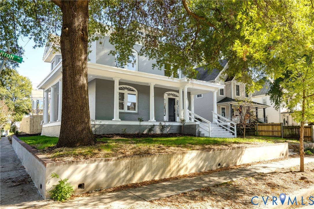 2005 Barton Avenue, Barton Heights, Richmond, VA 23222 Two-story residence featuring a covered wrap-around porch, classical columns, arched windows, and a raised concrete retaining wall