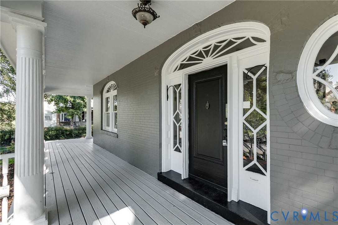 2005 Barton Avenue, Barton Heights, Richmond, VA 23222 Covered front porch featuring fluted columns, brick exterior, arched entryway with decorative fanlight transom, sidelights with geometric mullions, and circular accent window