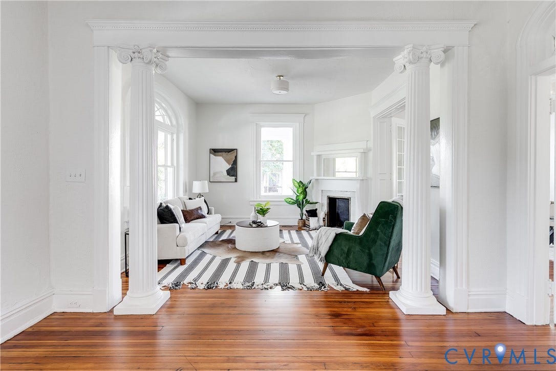 2005 Barton Avenue, Barton Heights, Richmond, VA 23222 Living area featuring fluted Ionic columns, wood-finish flooring, arched window detailing, and a fireplace with a mantel