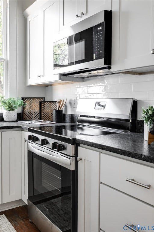 2005 Barton Avenue, Barton Heights, Richmond, VA 23222 White shaker-style cabinetry, dark stone countertops, stainless steel electric range, over-the-range microwave, and white subway tile backsplash