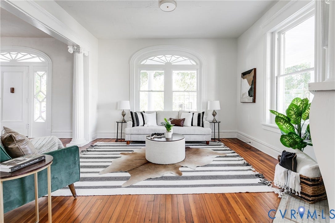 2005 Barton Avenue, Barton Heights, Richmond, VA 23222 Living area featuring wood-finish flooring, an arched window with detailed fanlight, and a classic fluted column