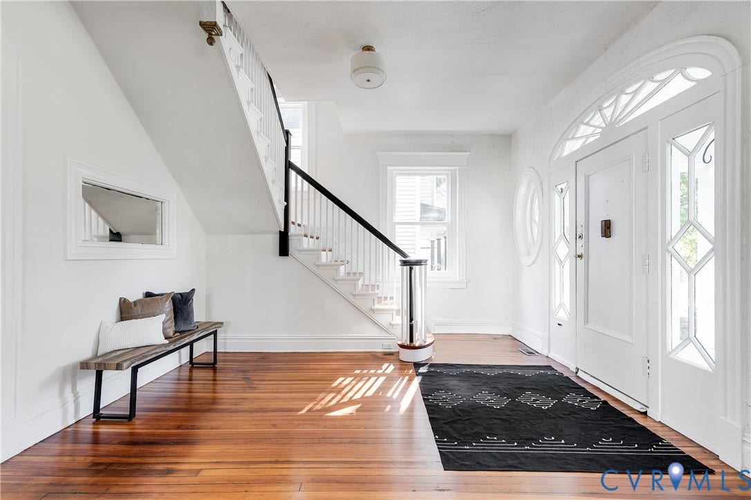 2005 Barton Avenue, Barton Heights, Richmond, VA 23222 Foyer featuring wood-finish flooring, a white front door with decorative glass sidelights and transom, and a staircase with white spindles and a dark handrail