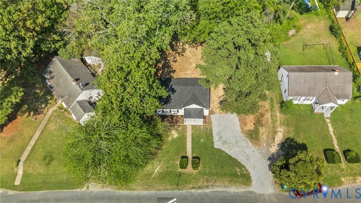 7406 Alycia Avenue, Henrico, VA 23228 White exterior residence with a dark shingle roof, front porch, and a gravel driveway