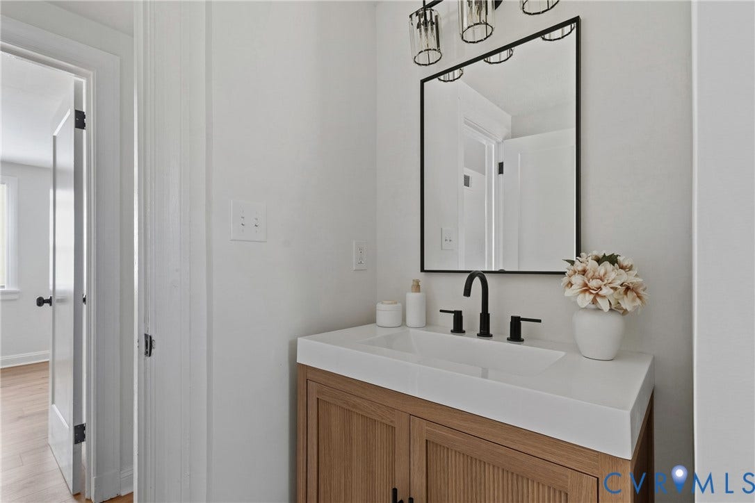 7406 Alycia Avenue, Henrico, VA 23228 Bathroom vanity with a white countertop and integrated sink, featuring a matte black faucet