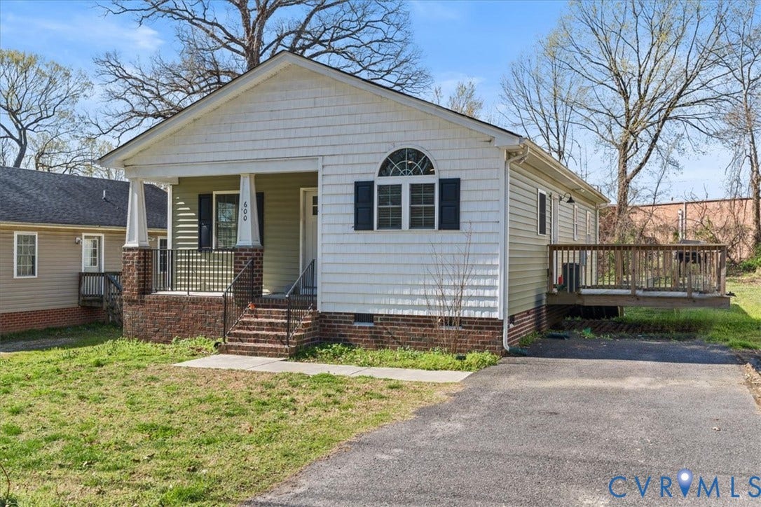 600 Highland Avenue, Hopewell, VA 23860 Exterior featuring a brick foundation, shake siding, covered front porch with tapered columns, arched window detailing, and an attached side deck