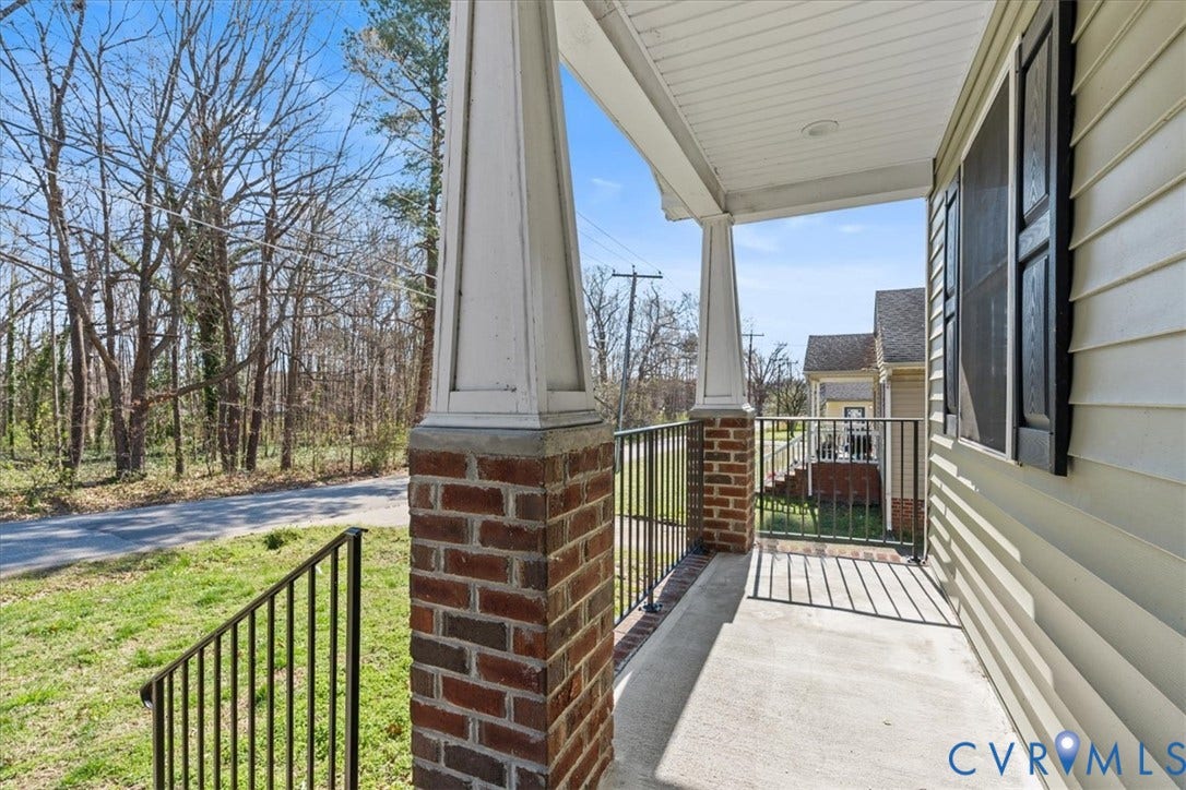 600 Highland Avenue, Hopewell, VA 23860 Covered porch featuring concrete flooring, brick-based columns with tapered pedestals, and black metal railings