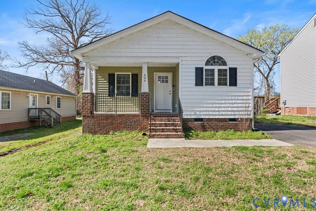 600 Highland Avenue, Hopewell, VA 23860 Craftsman-style exterior featuring shake siding, a covered front porch with brick base, iron railings, and an arched window accent