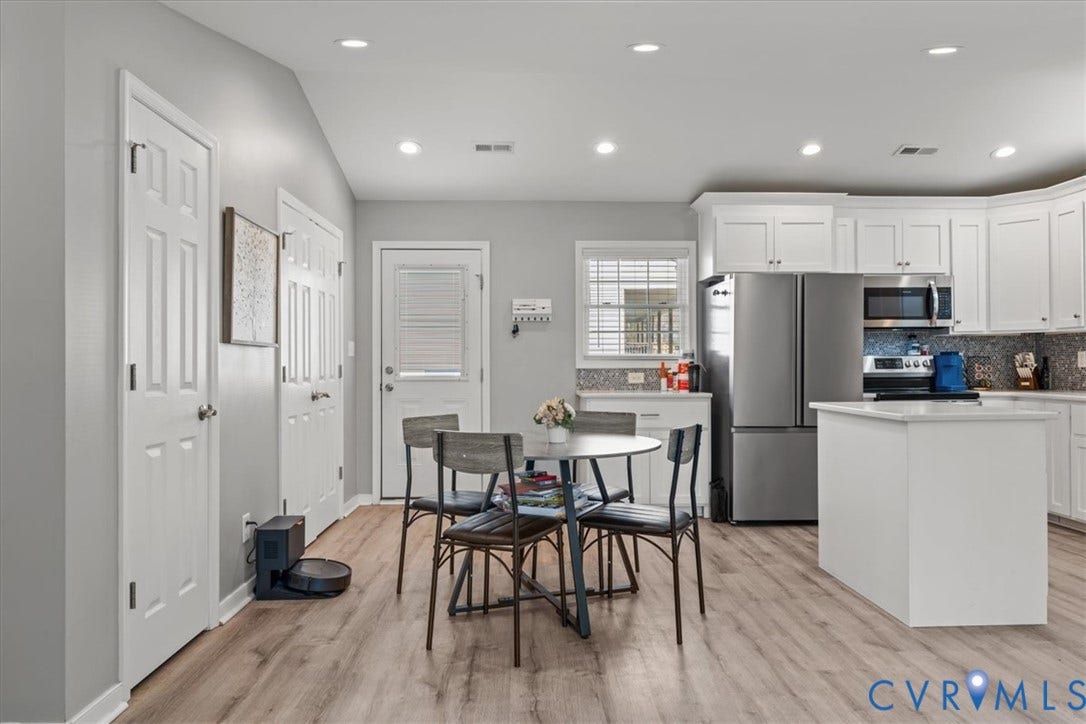 600 Highland Avenue, Hopewell, VA 23860 Kitchen featuring white cabinetry, stainless steel appliances, a central island, recessed lighting, and wood-finish flooring