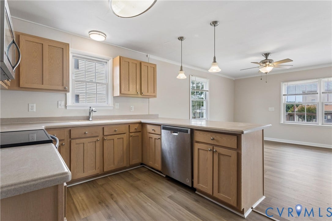 11 Bonita Drive, Hampton, VA 23664 Kitchen featuring wood cabinetry, stainless steel dishwasher, wood-finish flooring, dual pendant lighting, and a peninsula countertop