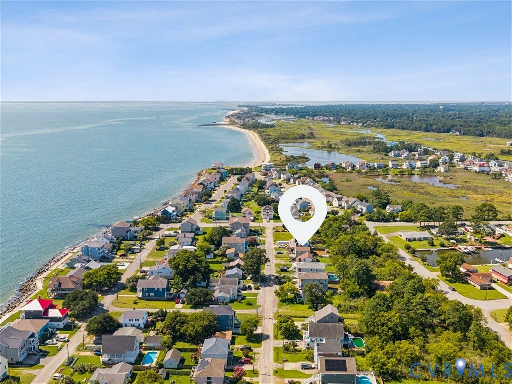 11 Bonita Drive, Hampton, VA 23664 Aerial perspective of residential coastal property featuring proximity to the shoreline, surrounding salt marsh ecosystems, and paved street access