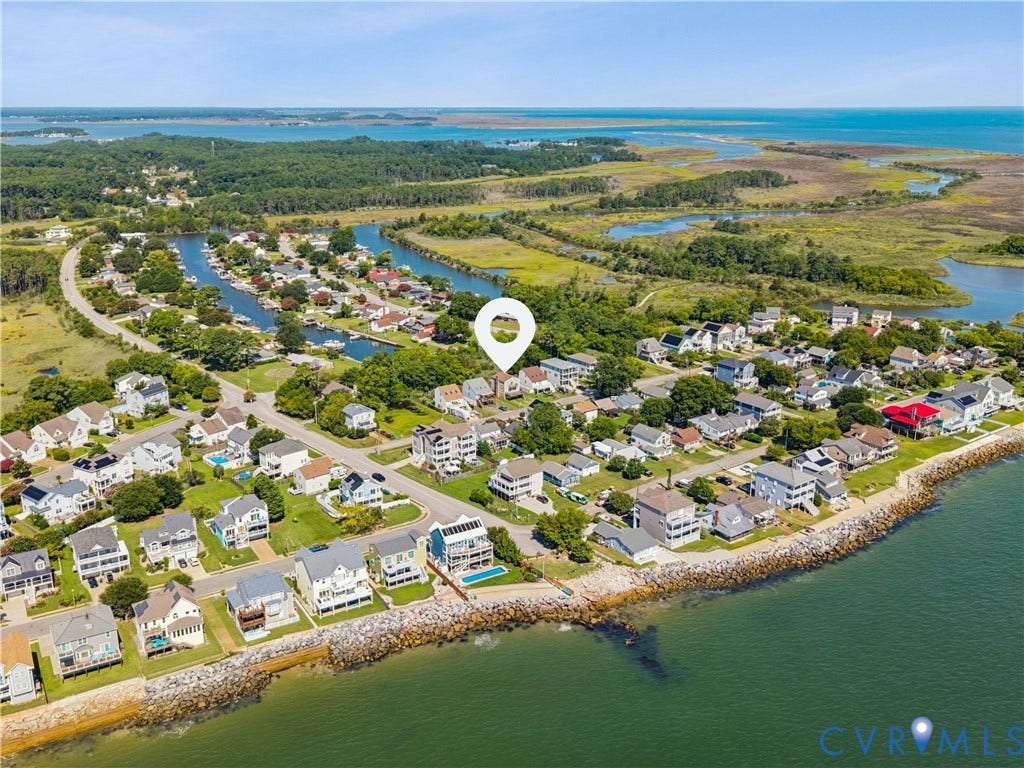 11 Bonita Drive, Hampton, VA 23664 Aerial perspective of a coastal property featuring direct water frontage, a private outdoor swimming pool, multi-level exterior decking, and proximity to natural salt marshes