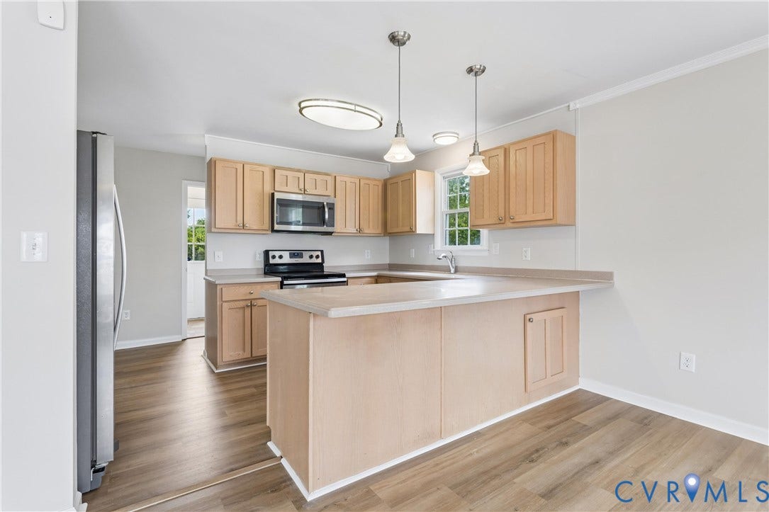 11 Bonita Drive, Hampton, VA 23664 Kitchen featuring light-finish cabinetry, a peninsula countertop, stainless steel appliances, dual pendant lighting, and wood-finish flooring