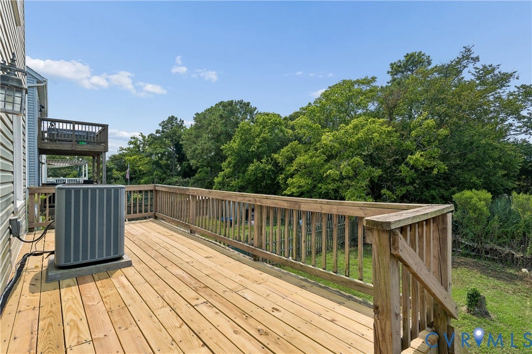 11 Bonita Drive, Hampton, VA 23664 Elevated wood deck featuring vertical wood balustrades and a secondary upper-level balcony