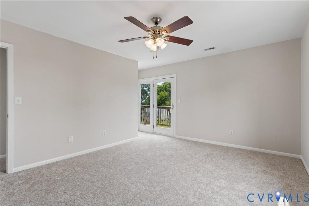 11 Bonita Drive, Hampton, VA 23664 Neutral-toned interior space featuring carpeting, a multi-blade ceiling fan with integrated light fixture, and glass-paneled double doors providing outdoor access