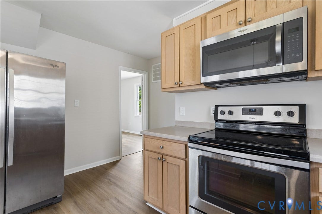 11 Bonita Drive, Hampton, VA 23664 Kitchen featuring natural wood-finish cabinetry, stainless steel appliances, solid surface countertops, and wood-finish flooring