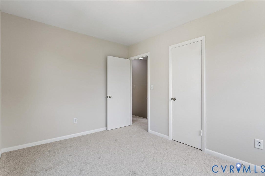 11 Bonita Drive, Hampton, VA 23664 Neutral interior room featuring neutral-toned walls, carpeted flooring, and two interior doors with brushed nickel hardware