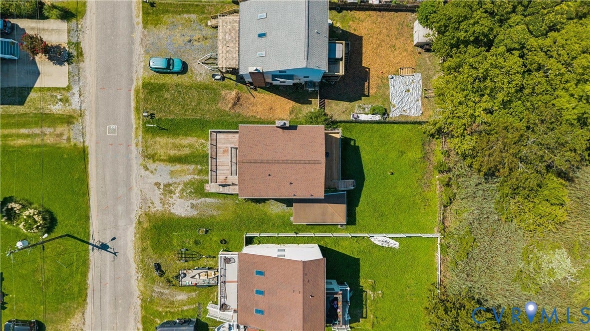11 Bonita Drive, Hampton, VA 23664 Aerial perspective featuring an expansive rear lawn, elevated wooden deck, and a multi-level structure with a gabled roof