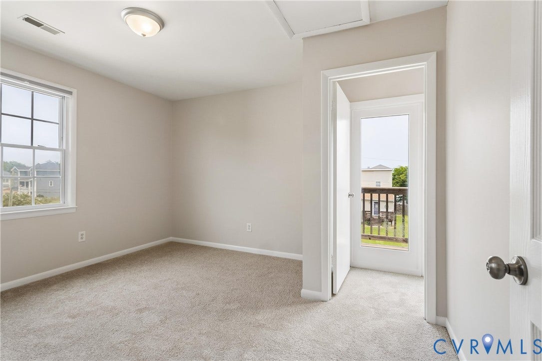 11 Bonita Drive, Hampton, VA 23664 Neutral wall tones, carpeted flooring, multi-pane window, flush-mount ceiling lighting, and door providing outdoor access
