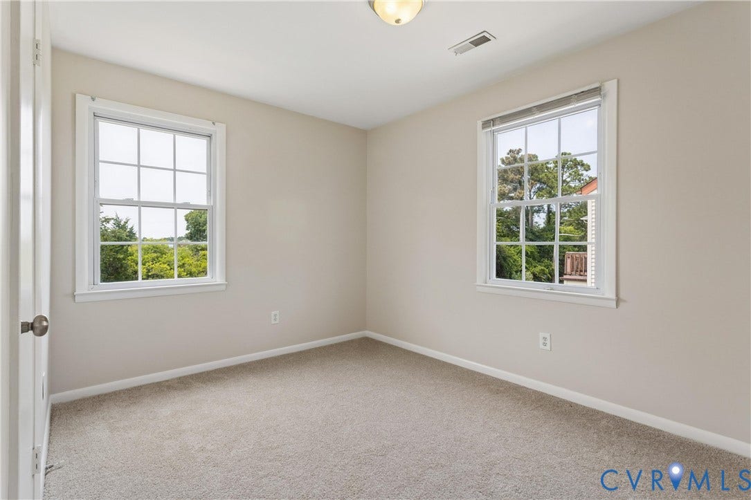 11 Bonita Drive, Hampton, VA 23664 Neutral-toned walls, wall-to-wall carpeting, dual double-hung windows with grid muntins, and a flush-mount ceiling light fixture