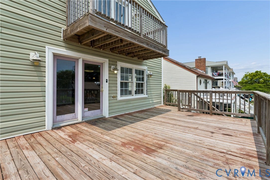 11 Bonita Drive, Hampton, VA 23664 Exterior wood deck with railings, horizontal siding, double-door entry, and a second-level balcony
