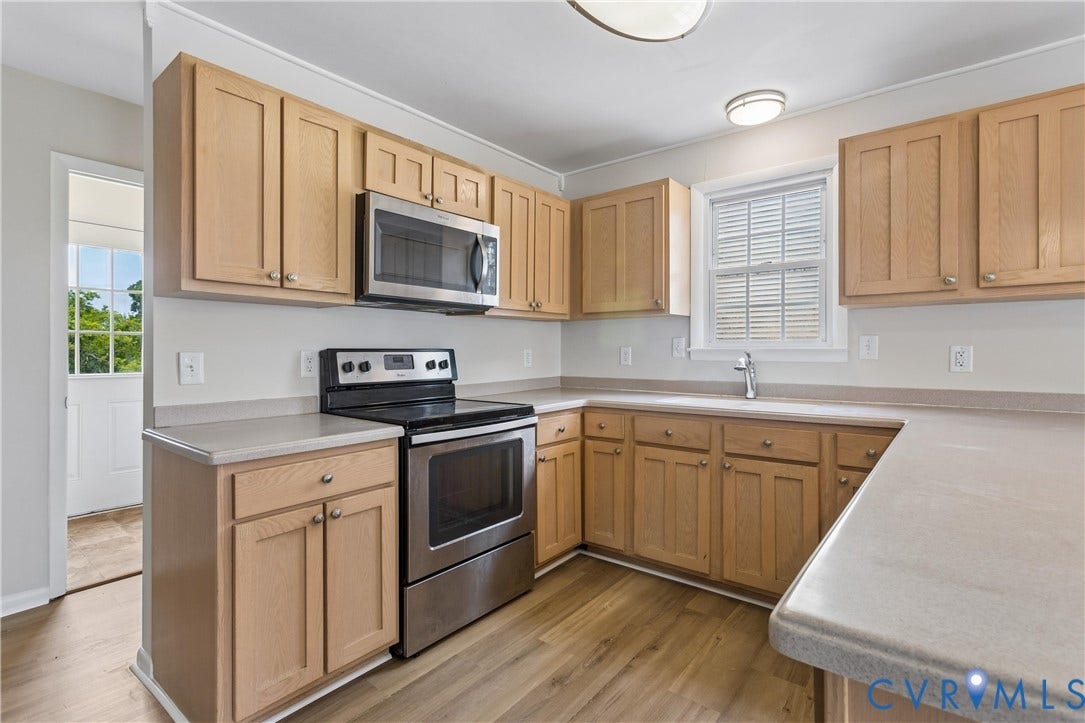 11 Bonita Drive, Hampton, VA 23664 Kitchen featuring wood cabinetry, stainless steel appliances, solid-surface countertops, and wood-finish flooring