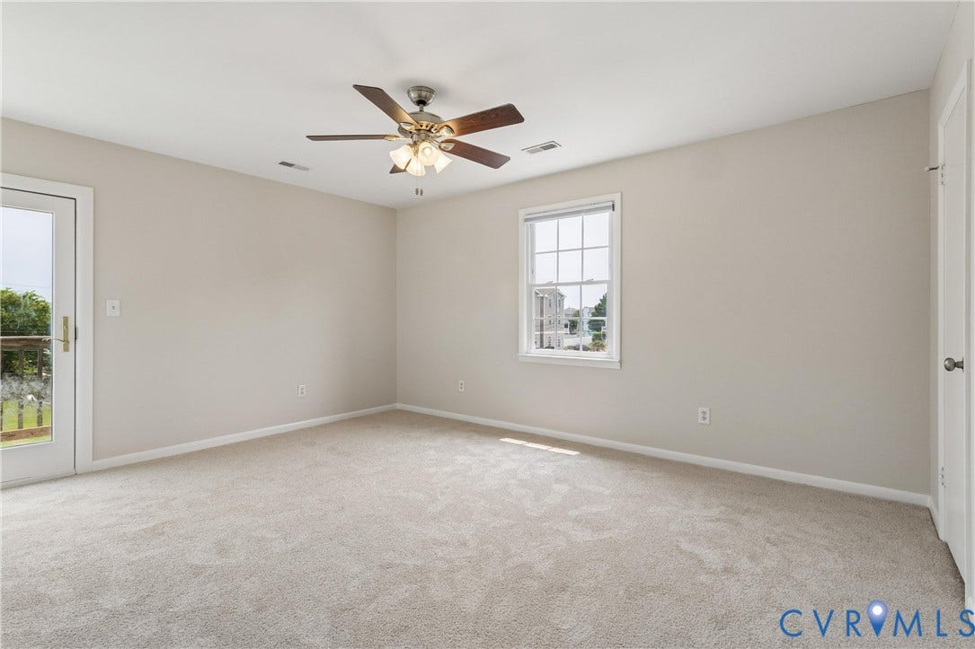 11 Bonita Drive, Hampton, VA 23664 Neutral-toned interior featuring wall-to-wall carpeting, a multi-light ceiling fan, a single-hung window with muntins, and a glass-paneled exterior door