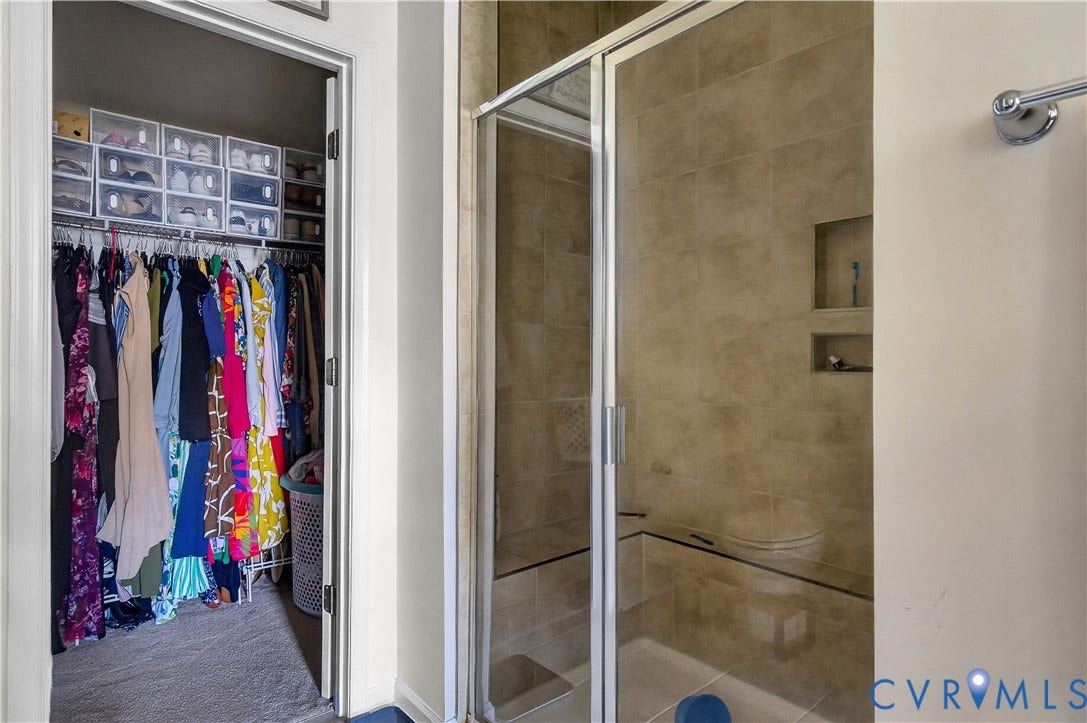 2230 Nightfall Drive, Chesterfield, VA 23236 Walk-in closet featuring wire shelving and a glass-enclosed shower with tile surround, built-in bench seating, dual wall niches, and polished chrome hardware