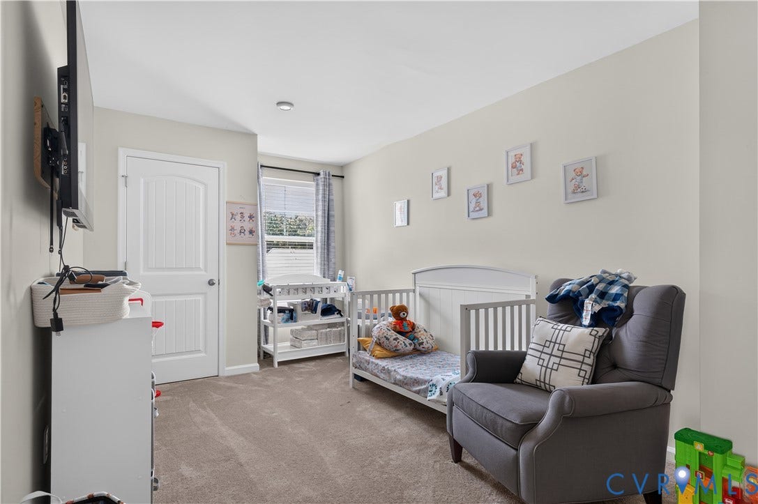 2230 Nightfall Drive, Chesterfield, VA 23236 Neutral-toned interior room featuring carpeted flooring, a multi-panel interior door, and a single-hung window with casing