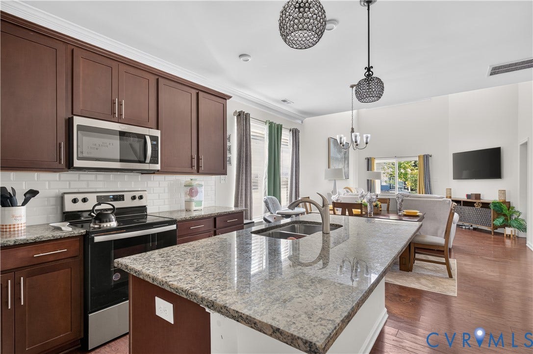 2230 Nightfall Drive, Chesterfield, VA 23236 Kitchen featuring dark-finish cabinetry, stone countertops, stainless steel appliances, subway tile backsplash, and wood-finish flooring