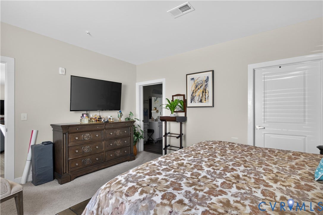3900 Maze Runner Drive, #102, Chesterfield, VA 23112 Neutral-toned interior space featuring light-colored wall paint, carpeted flooring, two interior passage doors, and recessed ceiling lighting