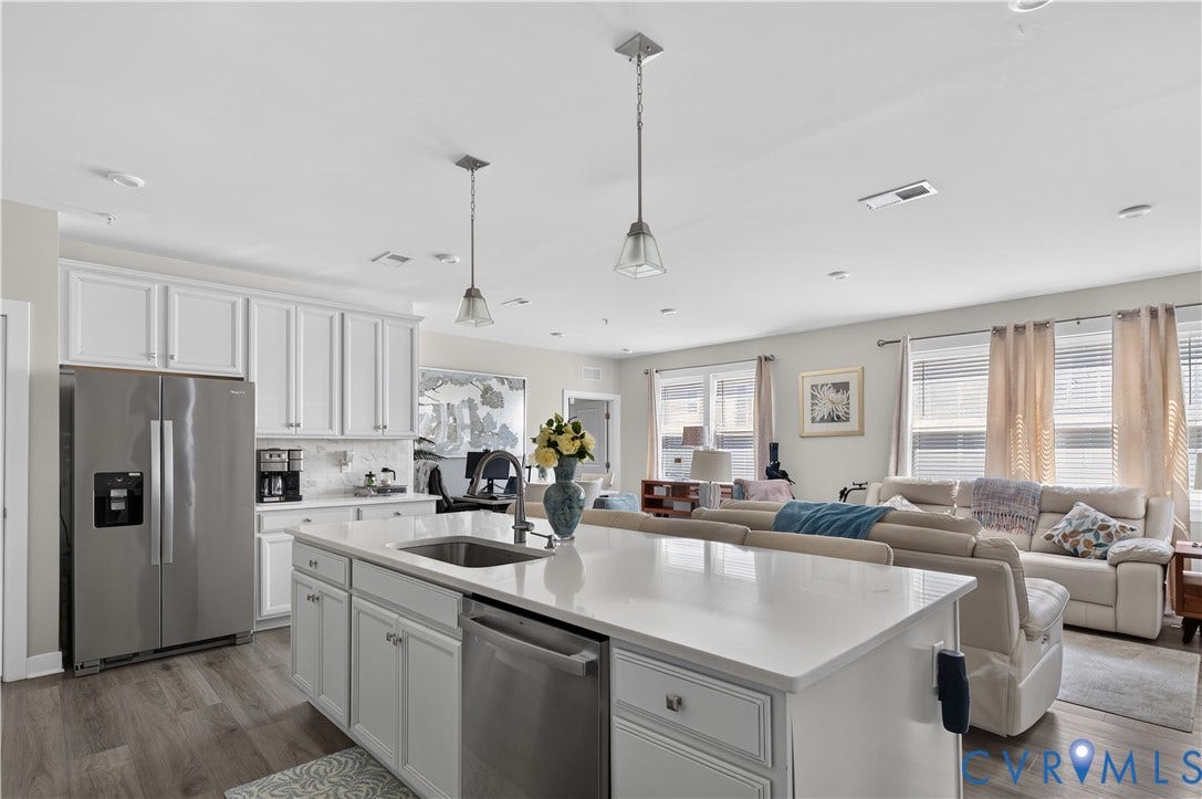 3900 Maze Runner Drive, #102, Chesterfield, VA 23112 Kitchen featuring white cabinetry, a center island with a stone-surface countertop, stainless steel appliances, and wood-finish flooring