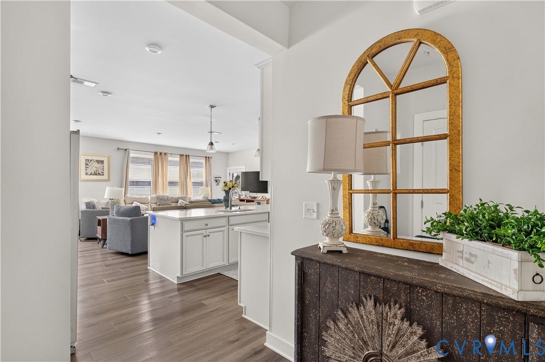 3900 Maze Runner Drive, #102, Chesterfield, VA 23112 Wood-finish flooring, white cabinetry, and stone-surface kitchen island