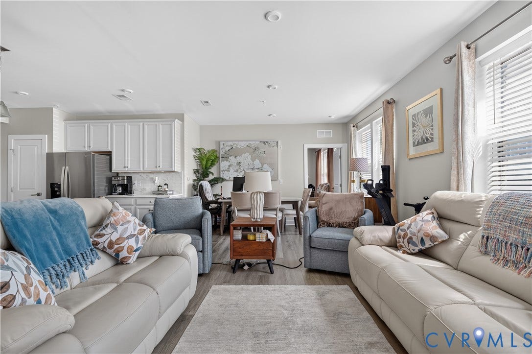 3900 Maze Runner Drive, #102, Chesterfield, VA 23112 Open-concept living space featuring wood-finish flooring, recessed lighting, and white cabinetry