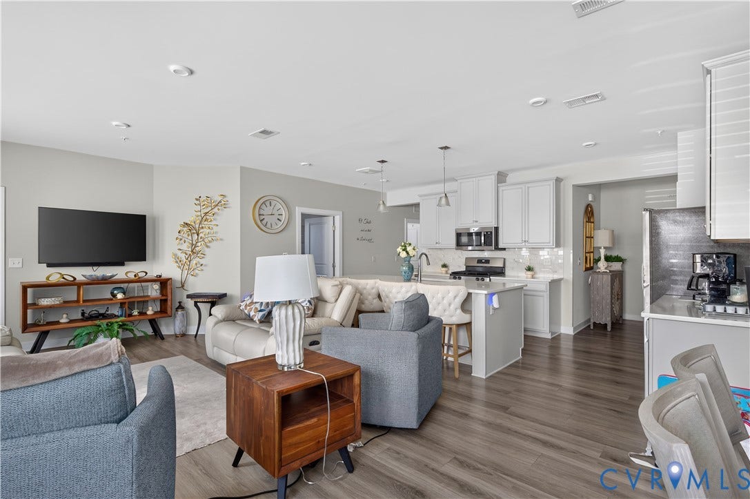 3900 Maze Runner Drive, #102, Chesterfield, VA 23112 Open-concept interior featuring wood-finish flooring, recessed lighting, and a kitchen equipped with white cabinetry, a central island, and stone-finish countertops