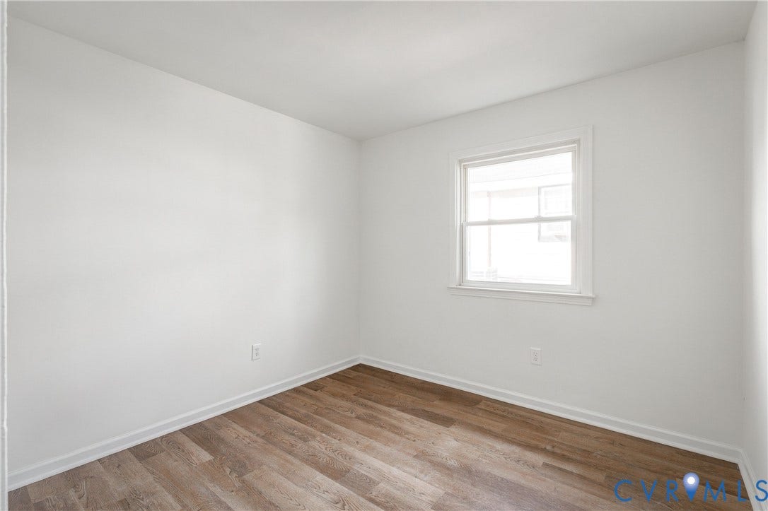 5429 Blueridge Avenue, Fulton, Richmond, VA 23231 Neutral-toned room featuring wood-finish flooring, white walls, and a single-pane window with white trim
