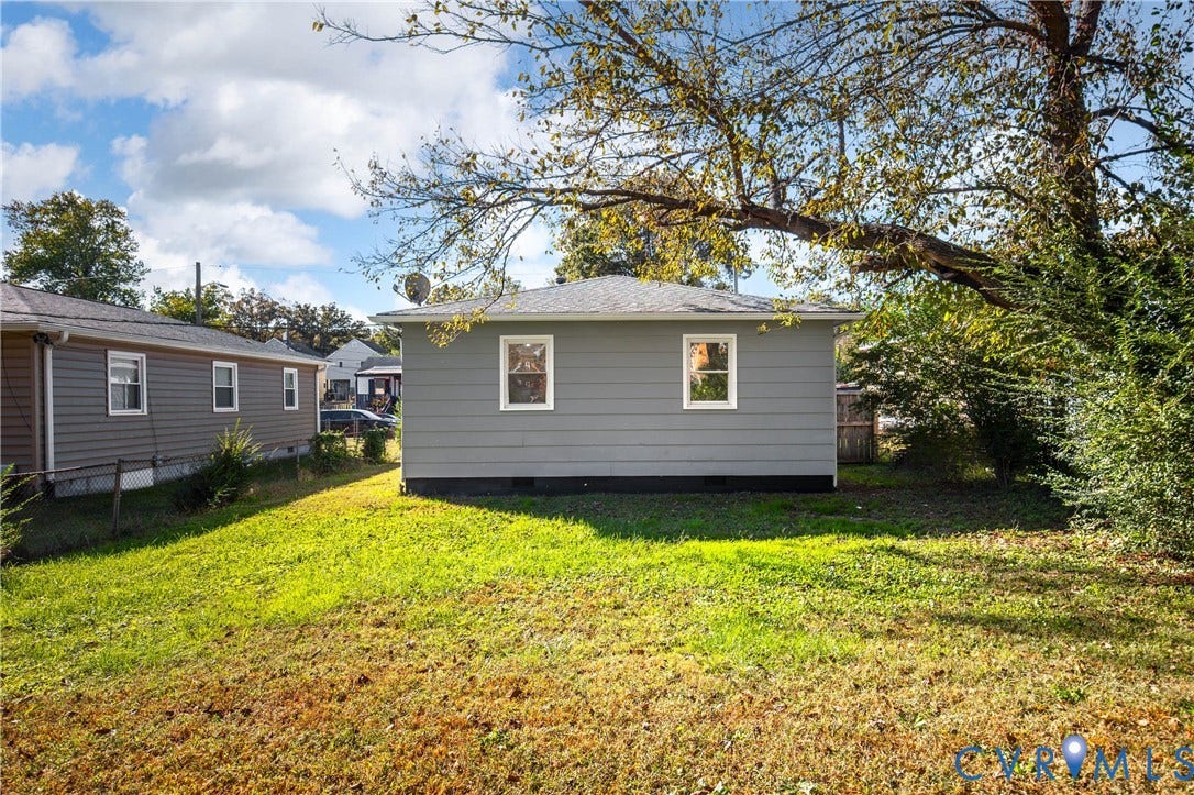 5429 Blueridge Avenue, Fulton, Richmond, VA 23231 Exterior featuring grey horizontal siding, a hipped roof, and dual white-framed windows, set on a grass-covered lot with mature trees