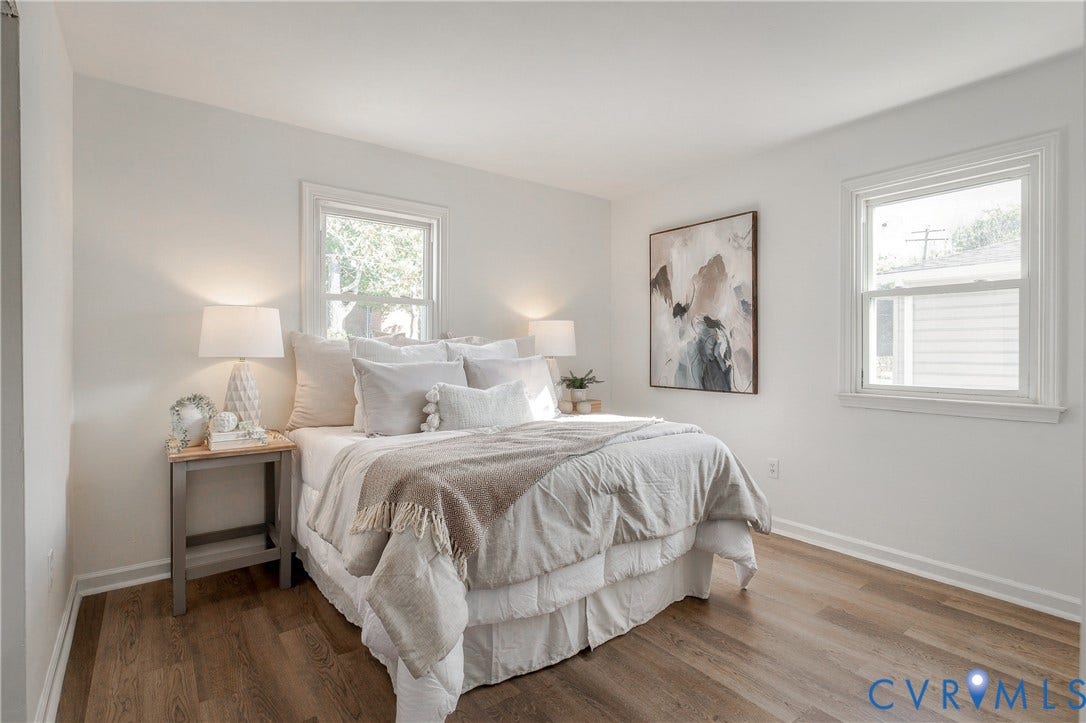 5429 Blueridge Avenue, Fulton, Richmond, VA 23231 Neutral interior featuring wood-finish flooring, two double-hung windows, and crisp white wall finishes